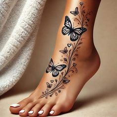 a woman's foot with butterflies and flowers on the top of her leg,