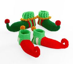 several knitted christmas stockings and booties on a white background