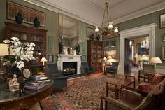 a living room filled with furniture and a fire place in the middle of a room