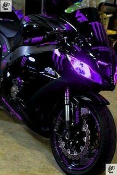 a purple and black motorcycle parked in a garage