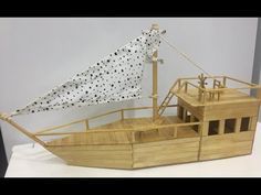 a wooden model of a boat with polka dots on it