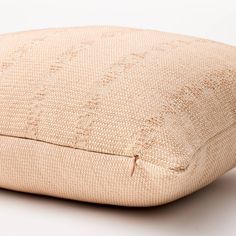 a close up of a pillow on a white surface with no one around it or someone else