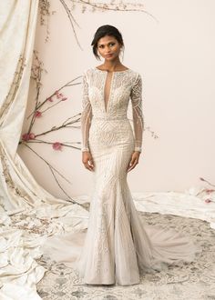 a woman in a wedding dress standing on a white carpet with pink flowers behind her