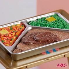 a metal tray filled with different types of food