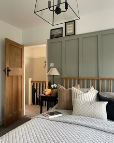 a bedroom with a large bed and wooden headboard