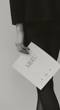 a person holding a piece of paper with the word utilin written on it