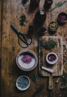 an overhead view of spices and herbs on a cutting board