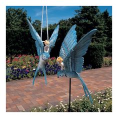 two blue birds on a swing with flowers in the background