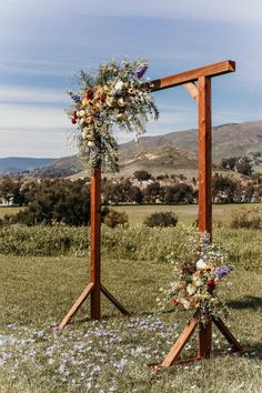 an outdoor ceremony setup with flowers and greenery