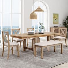 a dining room table with bench and chairs