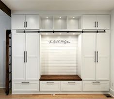 a large white closet with drawers and cabinets