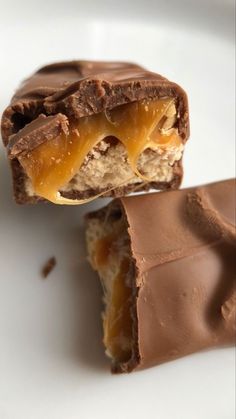 two pieces of chocolate with peanut butter on top