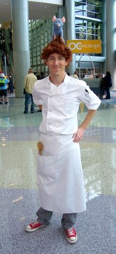 a man dressed as a chef standing in an airport