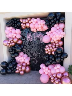 a door decorated with pink and black balloons