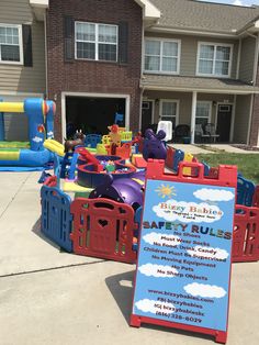 an inflatable bounce castle with a sign for safety rules on the front lawn