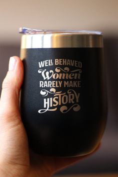 a person holding up a wine glass that says well behaved women rarely make history