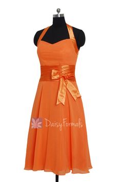 an orange bridesmaid dress on a mannequin dummy with the words daisy formals