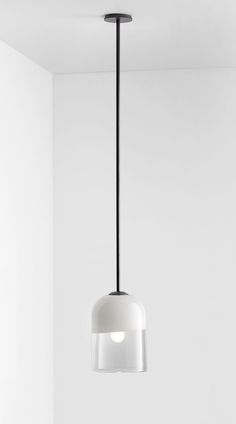 a white light hanging from a ceiling in a room with no one on the floor