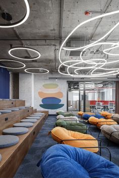 an office with lots of bean bags on the floor and tables in front of them