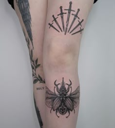 a woman's legs with tattoos on them and a tattoo design on the leg