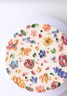 there is a cake decorated with flowers on the plate