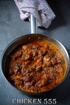 a pan filled with meat and sauce on top of a table