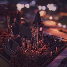 a model of a gothic church with crosses on the roof and steeples at night