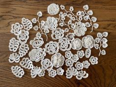 several white paper flowers on a wooden table