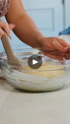 a woman is mixing ingredients in a bowl