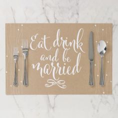 a place setting with silverware on top of a card that says eat drink and be married