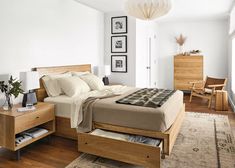 a bed room with a neatly made bed and wooden furniture