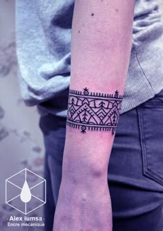 a woman's arm with a tattoo design on the left side of her arm