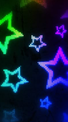 colorful stars are projected on the wall in this dark room, and it appears to be brightly colored