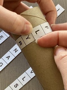 a person is holding a roll of paper with numbers on it and measuring the length