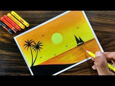 someone is drawing a sunset scene with crayons