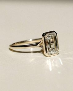 a diamond ring sitting on top of a table