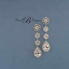 two pairs of diamond earrings on a blue background