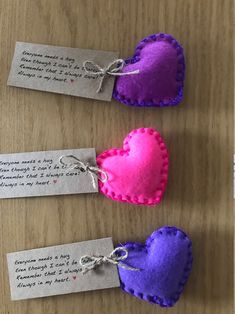 three small hearts with tags attached to them