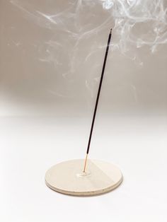 Enjoy the calming effects of aromatherapy with this minimalist, round Incense Holder featuring a unique and subtle two-tone design.  Wheel-thrown with a speckled stoneware clay, this ceramic incense plate showcases a beautiful contrast between its finishes: two-thirds glossy for a sleek, polished look, and one-third exposed raw clay with a soft, matte texture. This modern, minimalist design brings a sophisticated and calming touch to any room, perfect for aromatherapy and meditation. Ideal for h Burning Incense, Keramik Design, Incense Holders, Peterborough, Be Natural, Scandi Style, Incense Sticks, Incense Holder, Ceramic Design