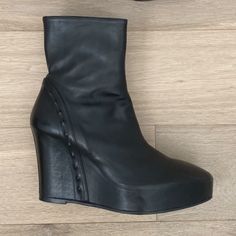 Ann Demeulemeester Black 125 Wedge Leather Ankle Boots With Stud Detail Size 41eu Retail $1340 Made In Italy Excellent Used Condition, Like New Comes With Original Box Black Leather 125mm Wedge Ankle Boots From Ann Demeulemeester Featuring Round Toe, Side Zip Fastening, Ankle-Length And High Wedge Heel. Unique Stud Detail Lining Heel These Black Ann Demeulemeester 125 Wedge Leather Ankle Boots Are Crafted In Italy With Almond Toes, Side Zip Fastenings And 125 Mm Wedge Heels. 5 Inch Heel With 1 I Formal Wedge Heel Platform Boots, Ann Demeulemeester Shoes, Ann Demeulemeester 90s, 2025 Wardrobe, Unique Studs, Rit Dye, Vegan Boots, High Wedges, Wedge Ankle Boots