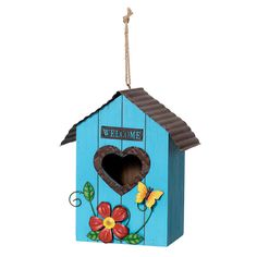 a blue birdhouse with a welcome sign on the roof and flowers painted on it