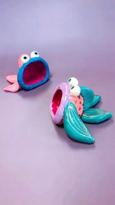 two toys that look like fish are sitting on the ground