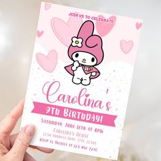 a person holding up a card with hello kitty on it