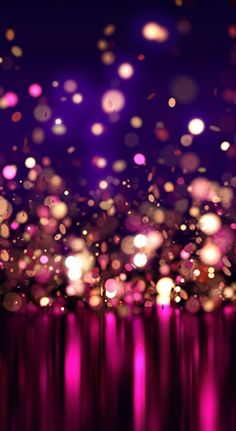 an abstract background with blurry lights in pink and purple