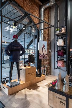 a man standing in the window of a shoe store