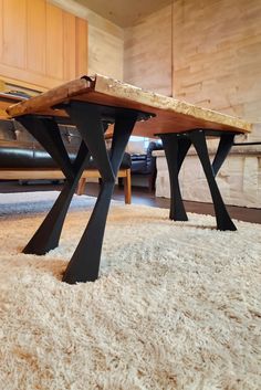 a wooden table sitting on top of a white rug