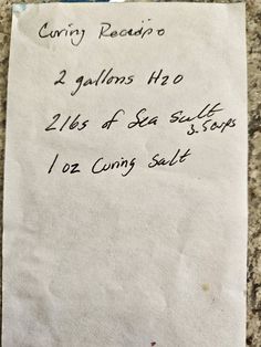 a piece of paper with writing on it sitting on top of a granite countertop