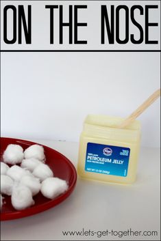 marshmallows are sitting on a red plate next to a container of toothpaste