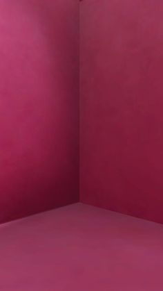 an empty room with pink walls and floor