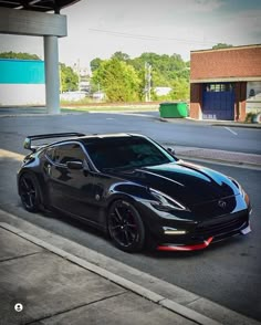 a black sports car parked in front of a parking garage